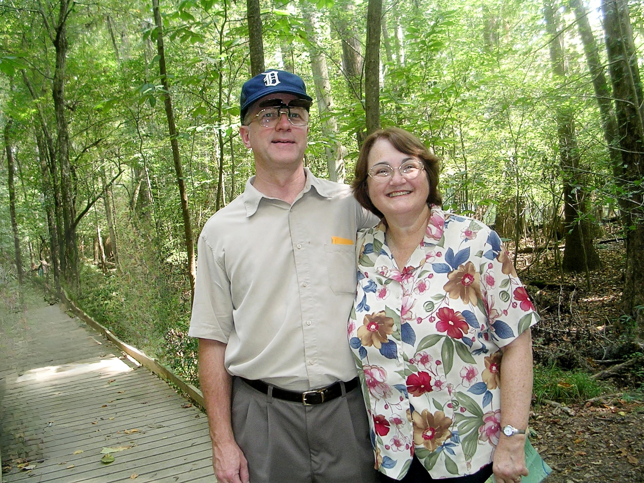 Gene and Marsha Frame standing in a forest